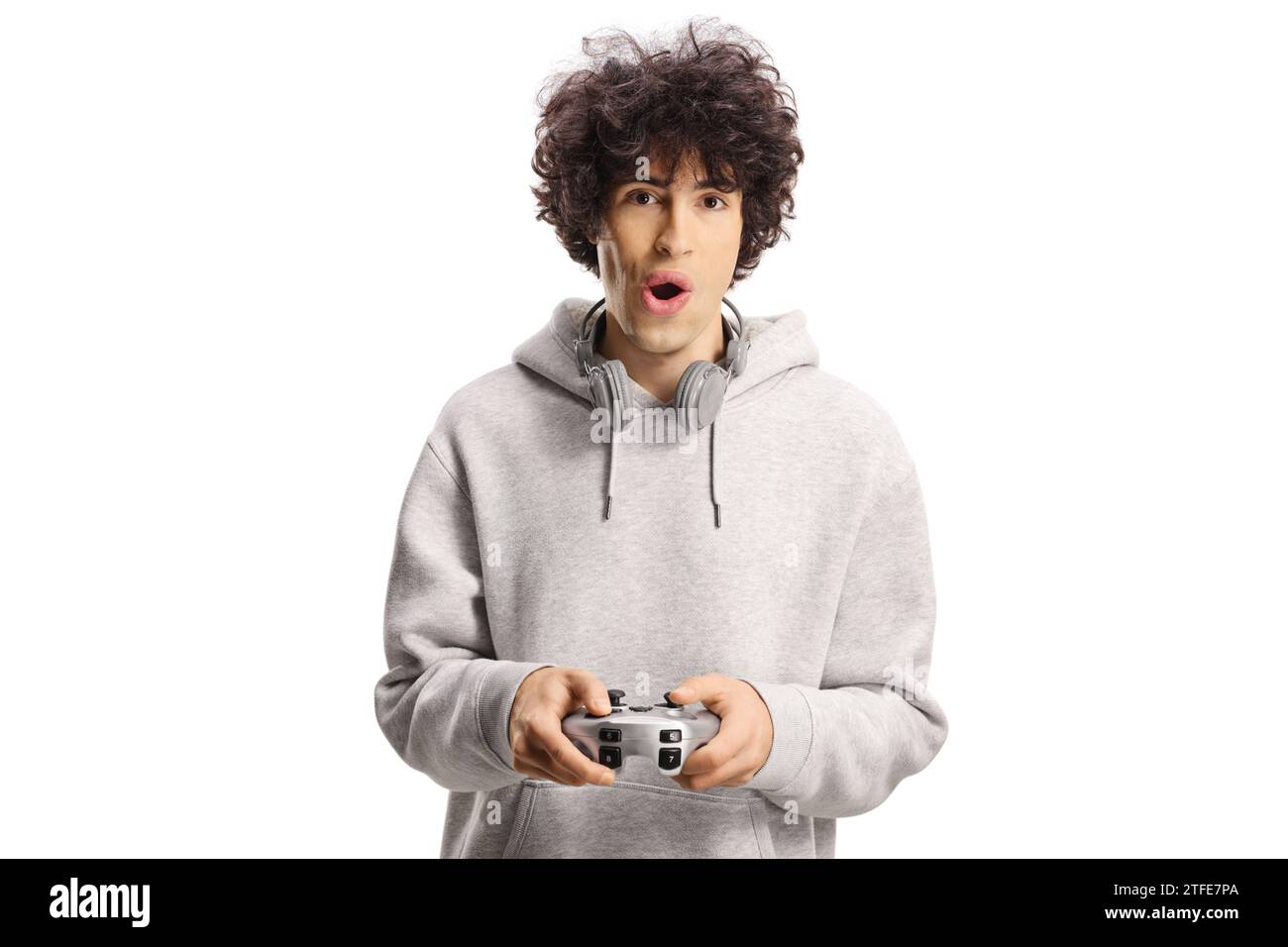 Excited young man playing a video game with joystick isolated on white background Stock Photo
