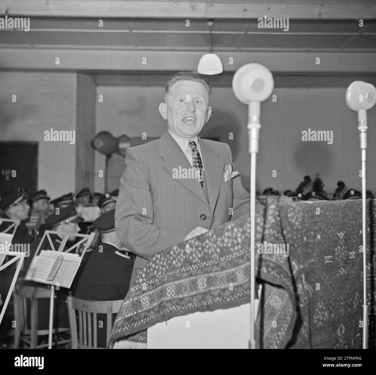 Man standing behind a lectern speaking ca. 1950 Stock Photo