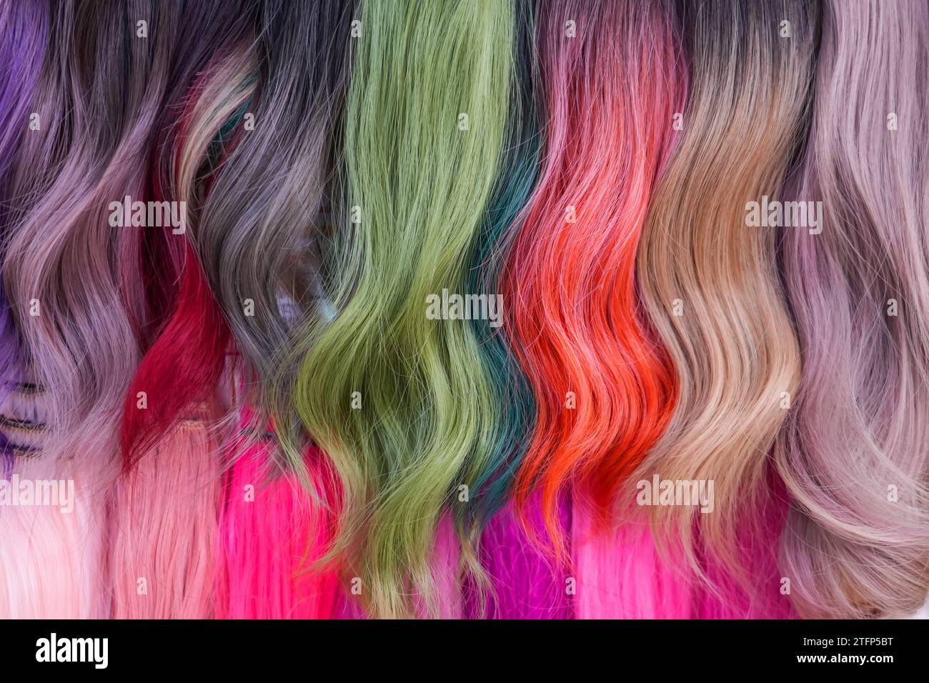 Hair samples of different colors palette. Different hair bright rich tint colors - pink, green, crimson, orange. Various hair colors set background cl Stock Photo