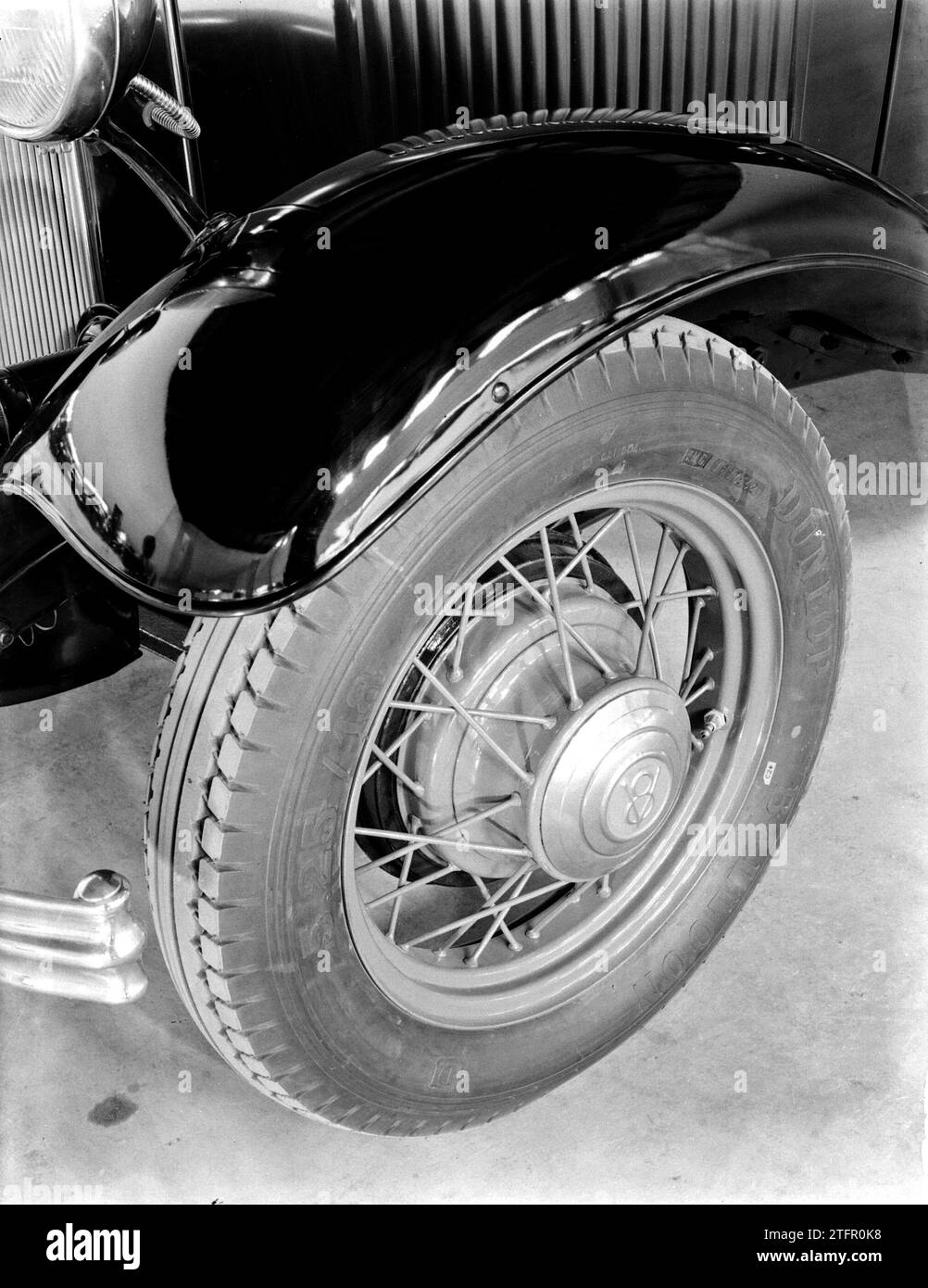 Detail of a Ford car. Spoke wheel, tire and mudguard ca. 1932 Stock Photo