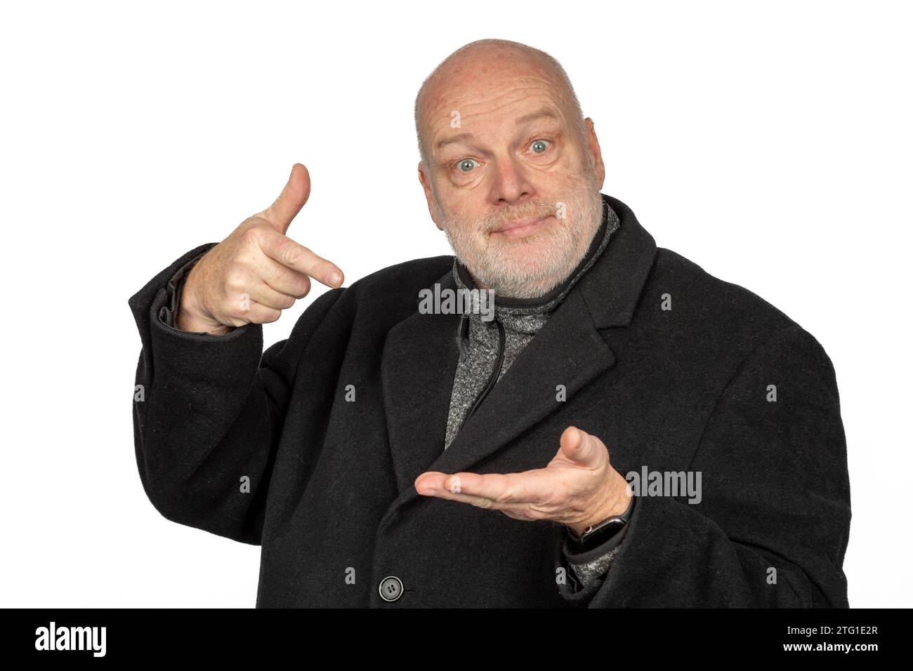 Happy 58-Year-Old Man in Winter Coat Looking in Camera and Holding Something Stock Photo