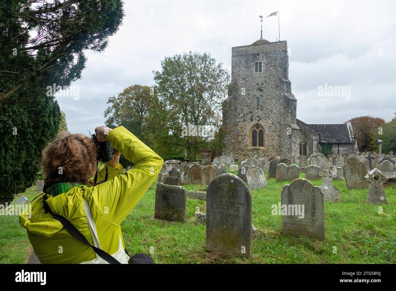 Woman taking photo of church, old gravestones, graveyard, Steyning, West Sussex, Sussex, England, Great Britain Stock Photo