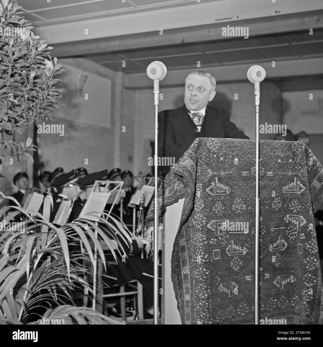 Man standing behind a carpeted lectern ca. 1950 Stock Photo