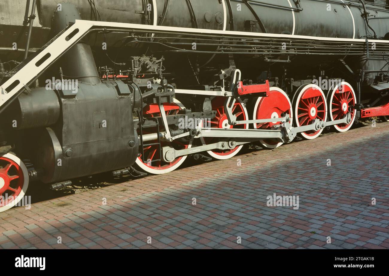 Wheels of the old black steam locomotive of Soviet times. The side of ...