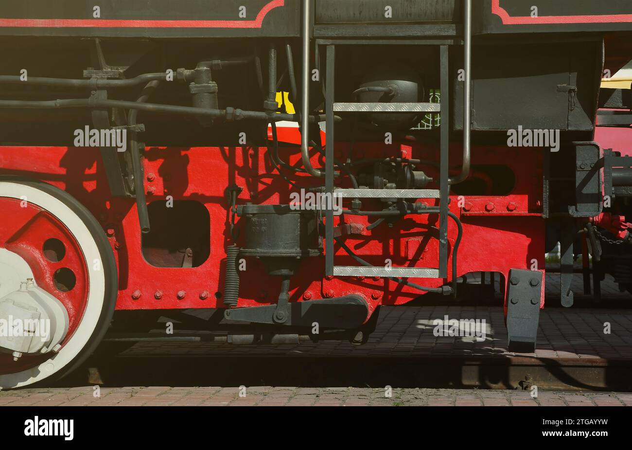 Wheels of the old black steam locomotive of Soviet times. The side of ...