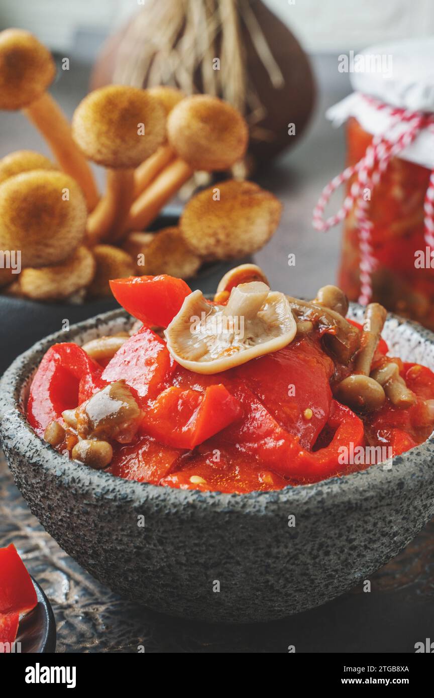Lecho made of peppers, tomatoes and honey fungus mushroom . Home cooking for winter. Cold appetizer. Preparation for cooking the first course. Close-u Stock Photo