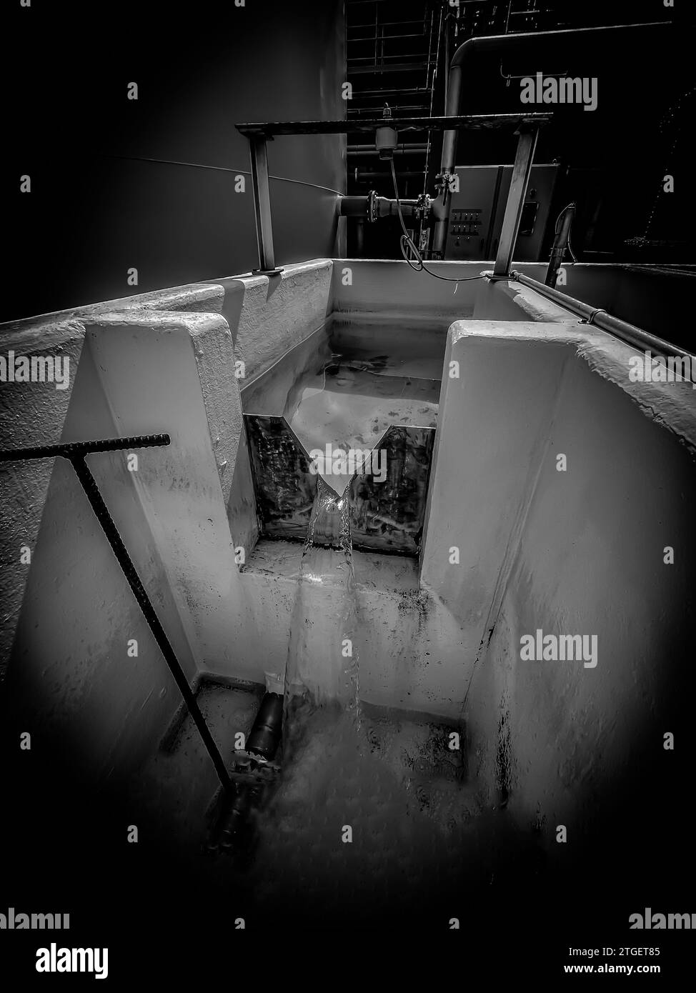 Industrial weir for measure flow of water through a Vnotch Stock Photo