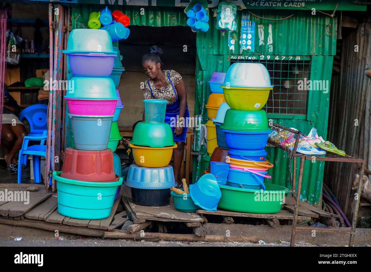 A hawker sells products at her stall in Kibera Slum of Nairobi, Kenya. A view through the everyday life in Kibera currently Africa’s largest Slum and Stock Photo