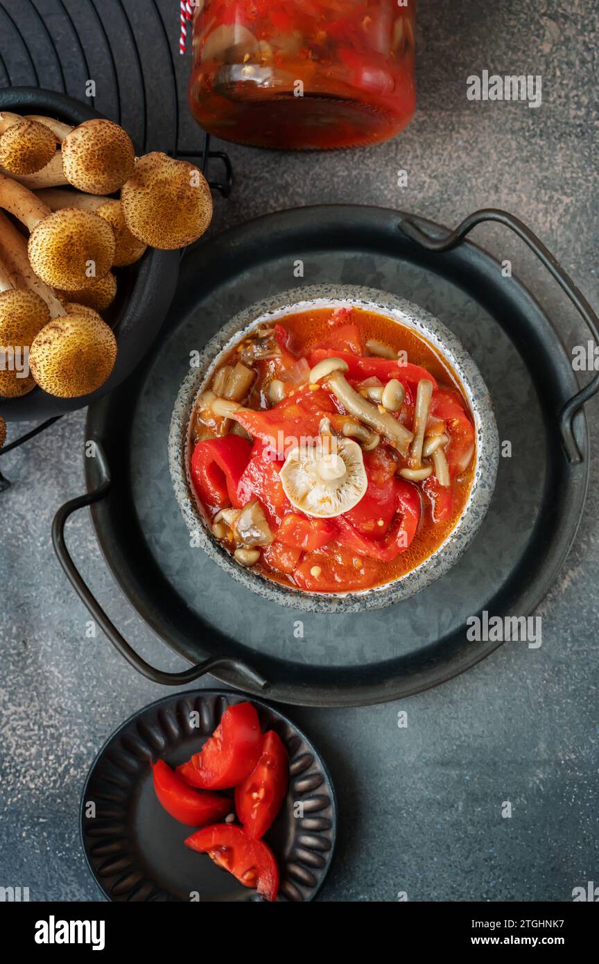 Lecho made of peppers, tomatoes and honey fungus mushroom . Home cooking for winter. Cold appetizer. Preparation for cooking the first course. Top vie Stock Photo