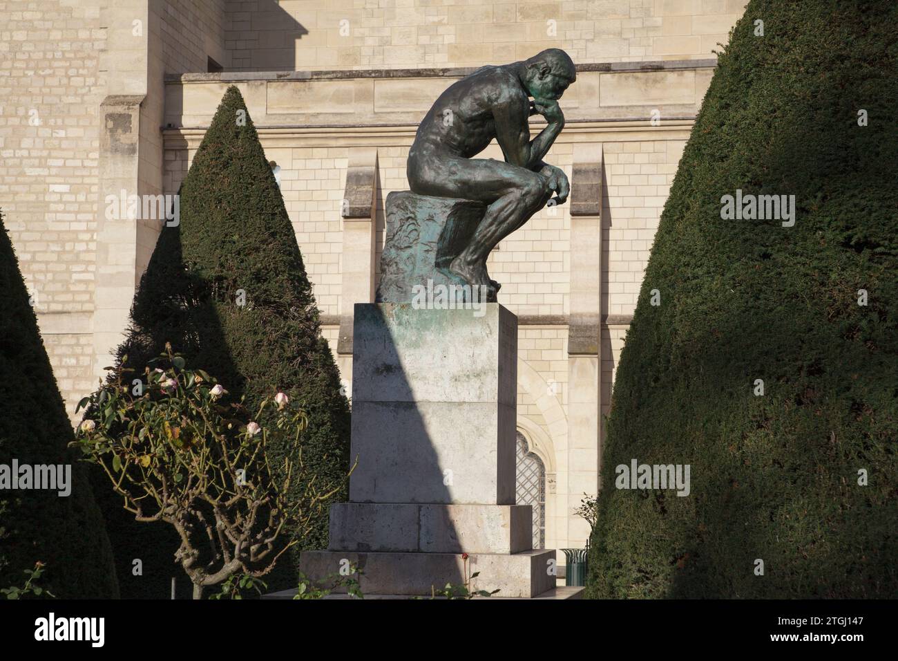 A cast of The Thinker, an iconic sculpture by Rodin in the gardens at Musée Rodin in Paris, France Stock Photo