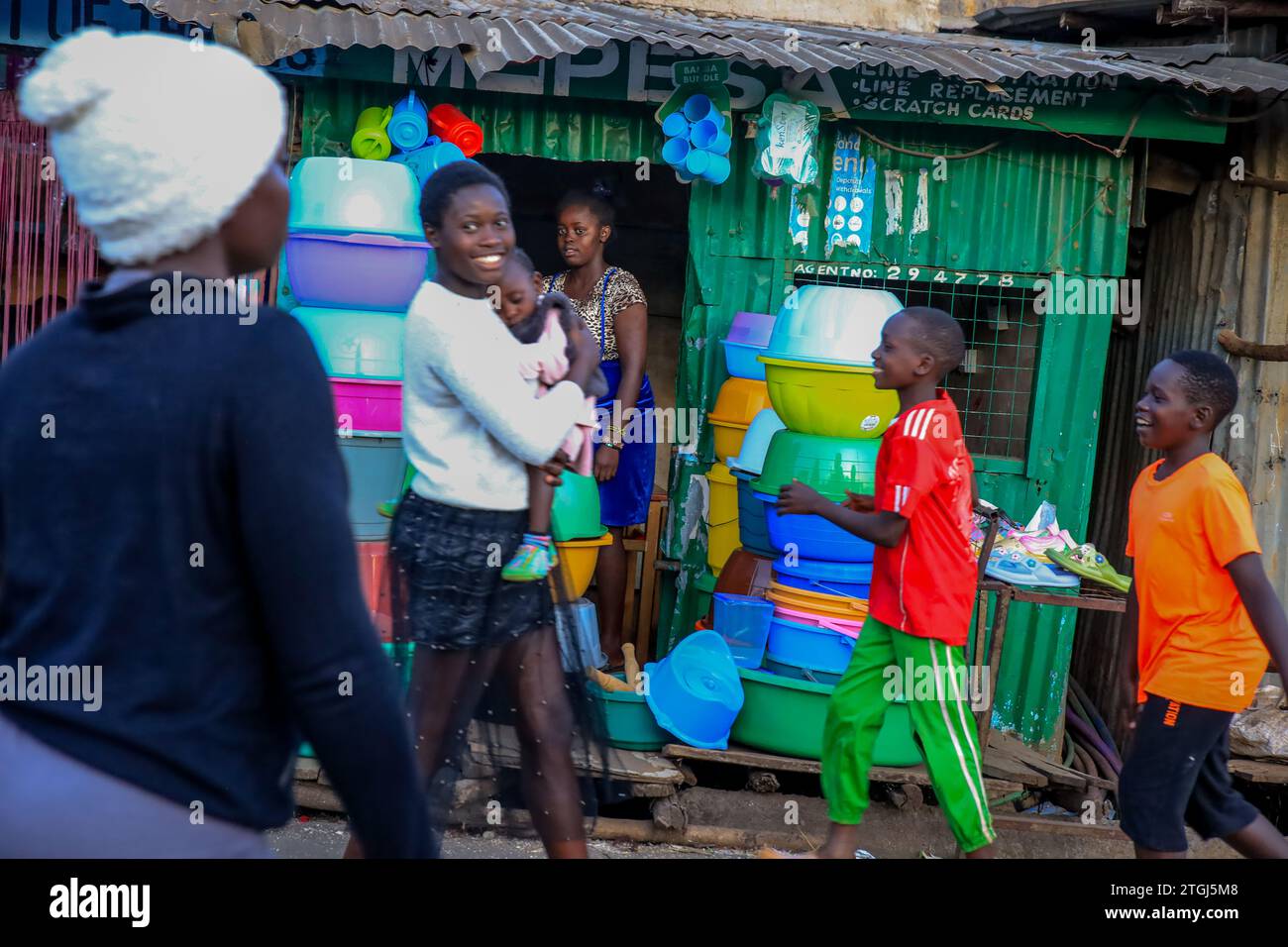 A hawker sells products at her stall in Kibera Slum of Nairobi, Kenya. A view through the everyday life in Kibera currently Africa’s largest Slum and Stock Photo