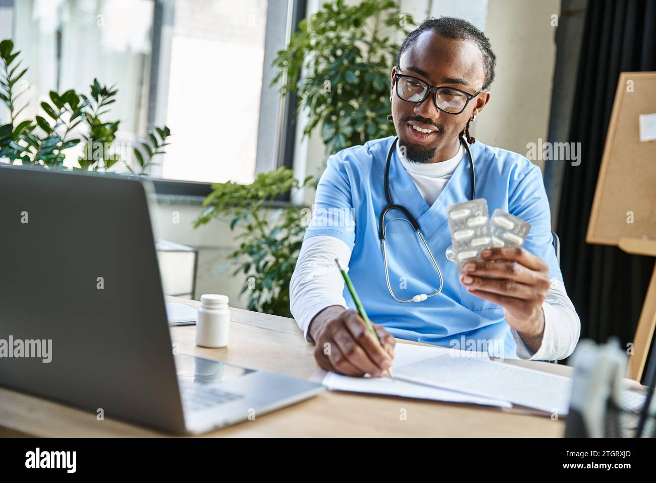 Male doctor taking notes laptop hi-res stock photography and images - Alamy
