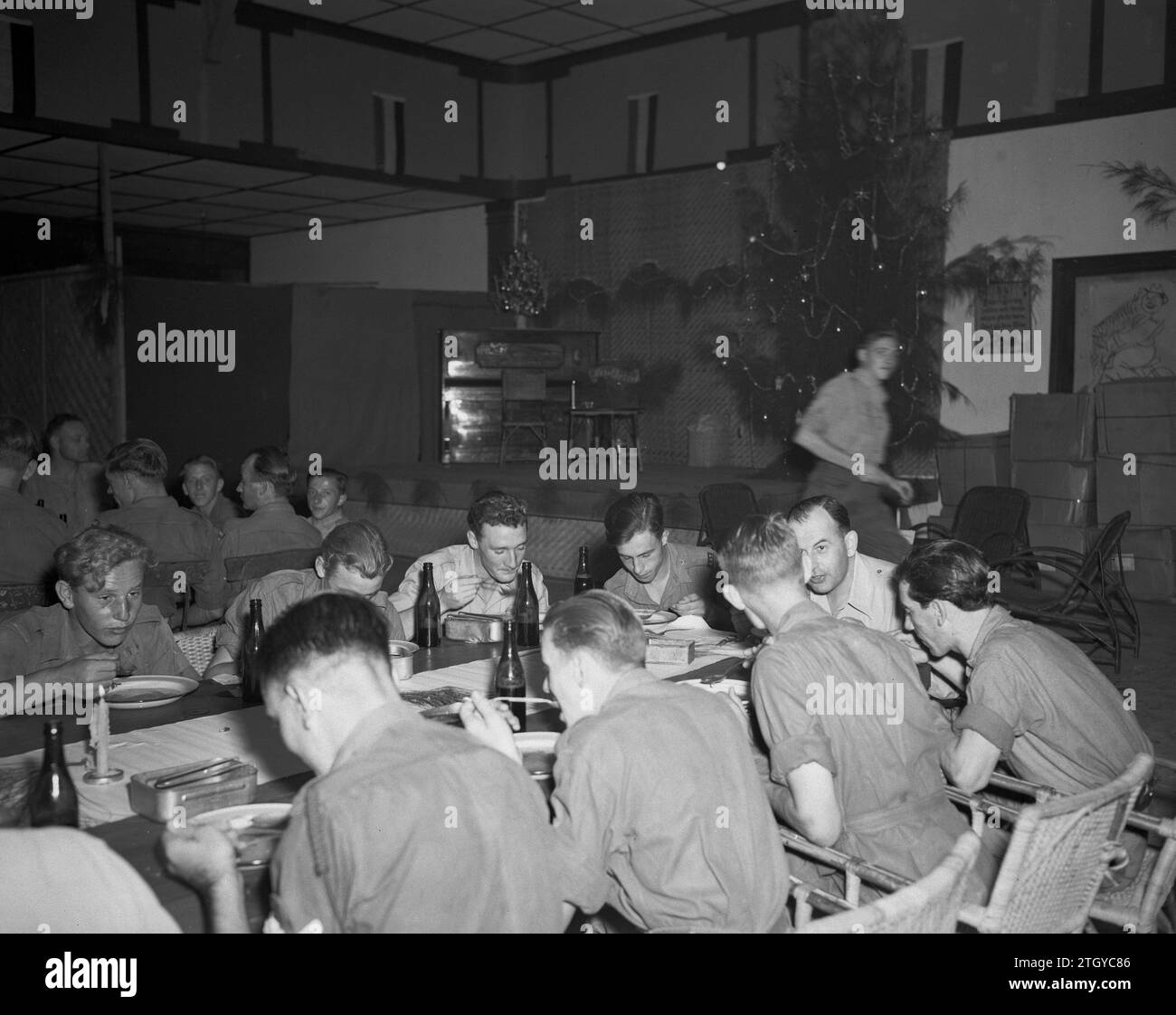 Dutch Soldiers sharing a common meal during the Christmas celebration ca. December 25, 1946 Stock Photo