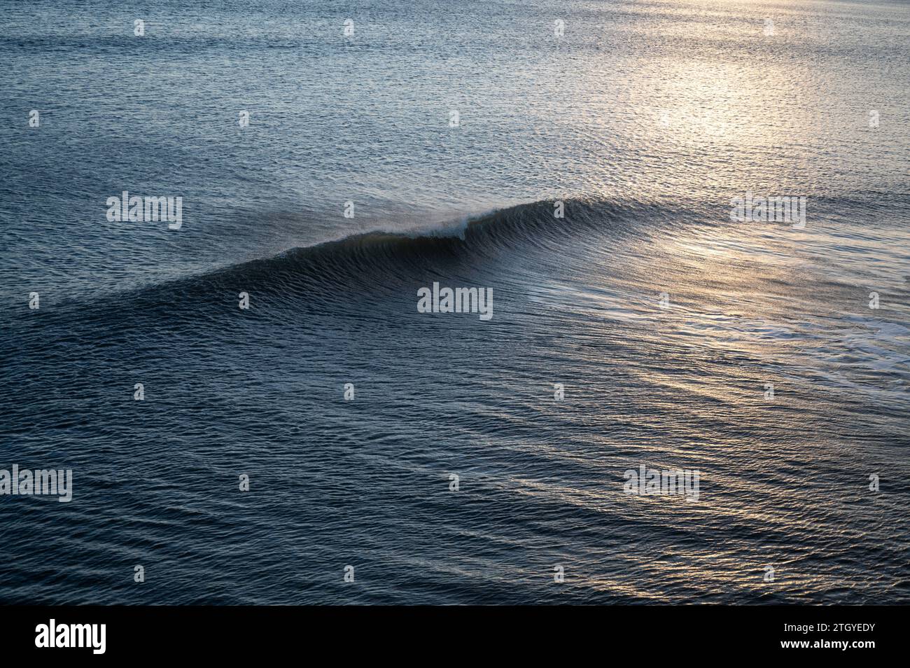 waves at Bournemouth backlit sunset Stock Photo