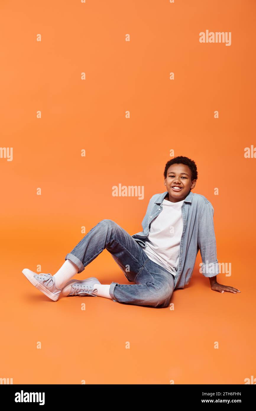 African boy sitting on floor hi-res stock photography and images - Alamy