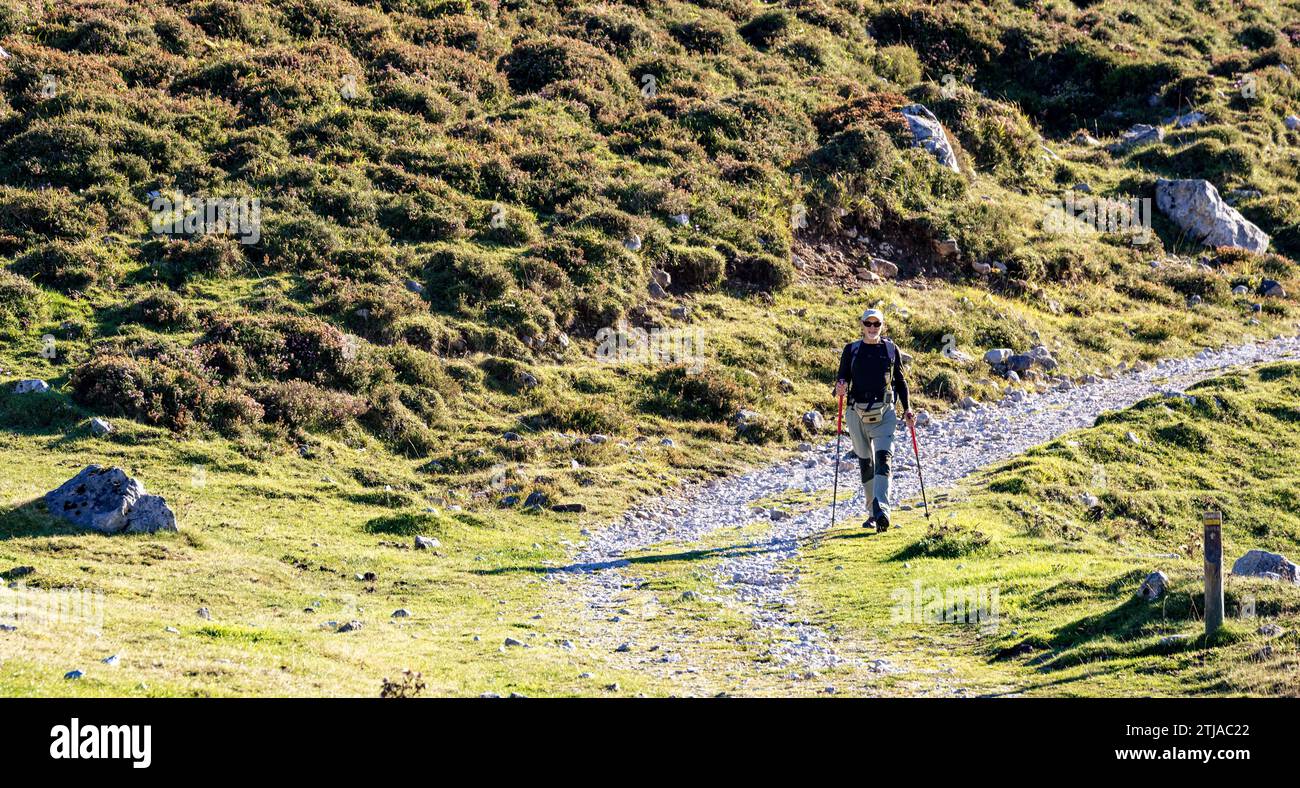 Hiker walking the trail. Jito de Escarandi, on the border between Asturias and Cantabria, is the starting point for many excursions. Jito de Escarando Stock Photo
