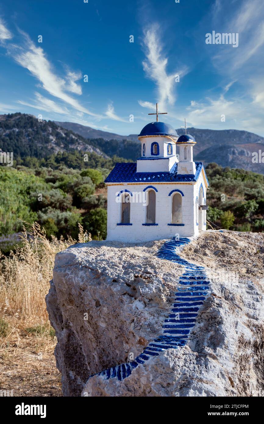 Small blue and white church on a rock near village of zia on kos island, greece. Stock Photo