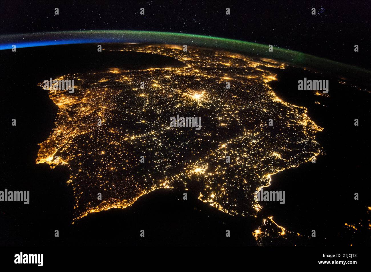 Iberian Peninsula at Night taken from the International Space Station, 26 July 2014. One of the Expedition 40 crew members aboard the International Space Station recorded this early evening photo of the entire Iberian Peninsula (Spain, Portugal and Andorra) on 26 July 2014. Part of France can be seen at the top of the image and the Strait of Gibraltar is visible at bottom, with a very small portion of Morocco visible near the lower right corner.  An Optimised version of an original NASA image / Credit: NASA Stock Photo