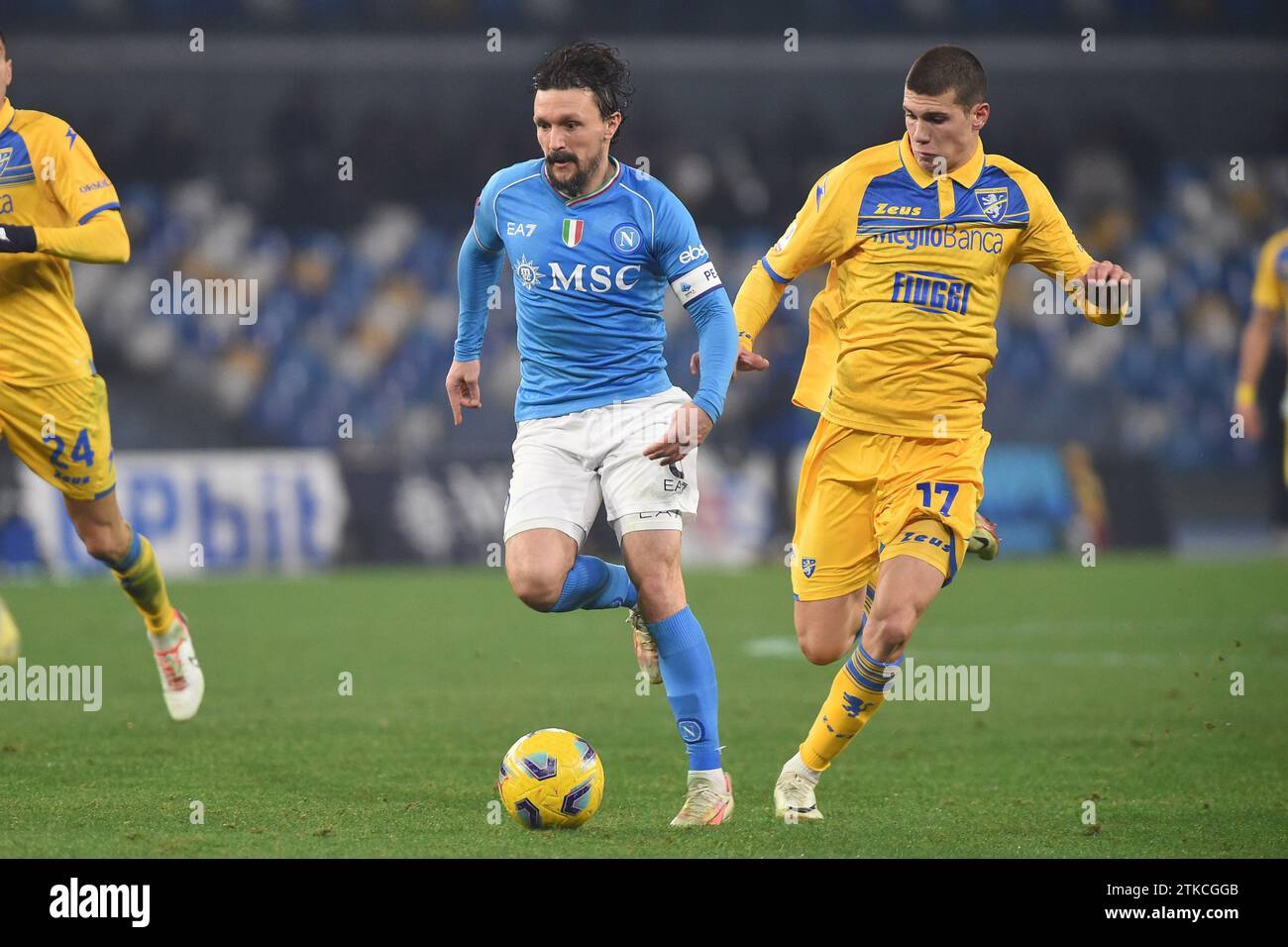 Naples, Italy. 19 Dec, 2023. Giorgi Kvernadze of Frosinone Calcio competes for the ball with Mario Rui of SSC Napoli during the Coppa Italia match between SSC Napoli and Frosinone Calcio at Stadio Diego Armando Maradona Naples Italy on 19 December 2023. Credit:Franco Romano/Alamy Live News Stock Photo