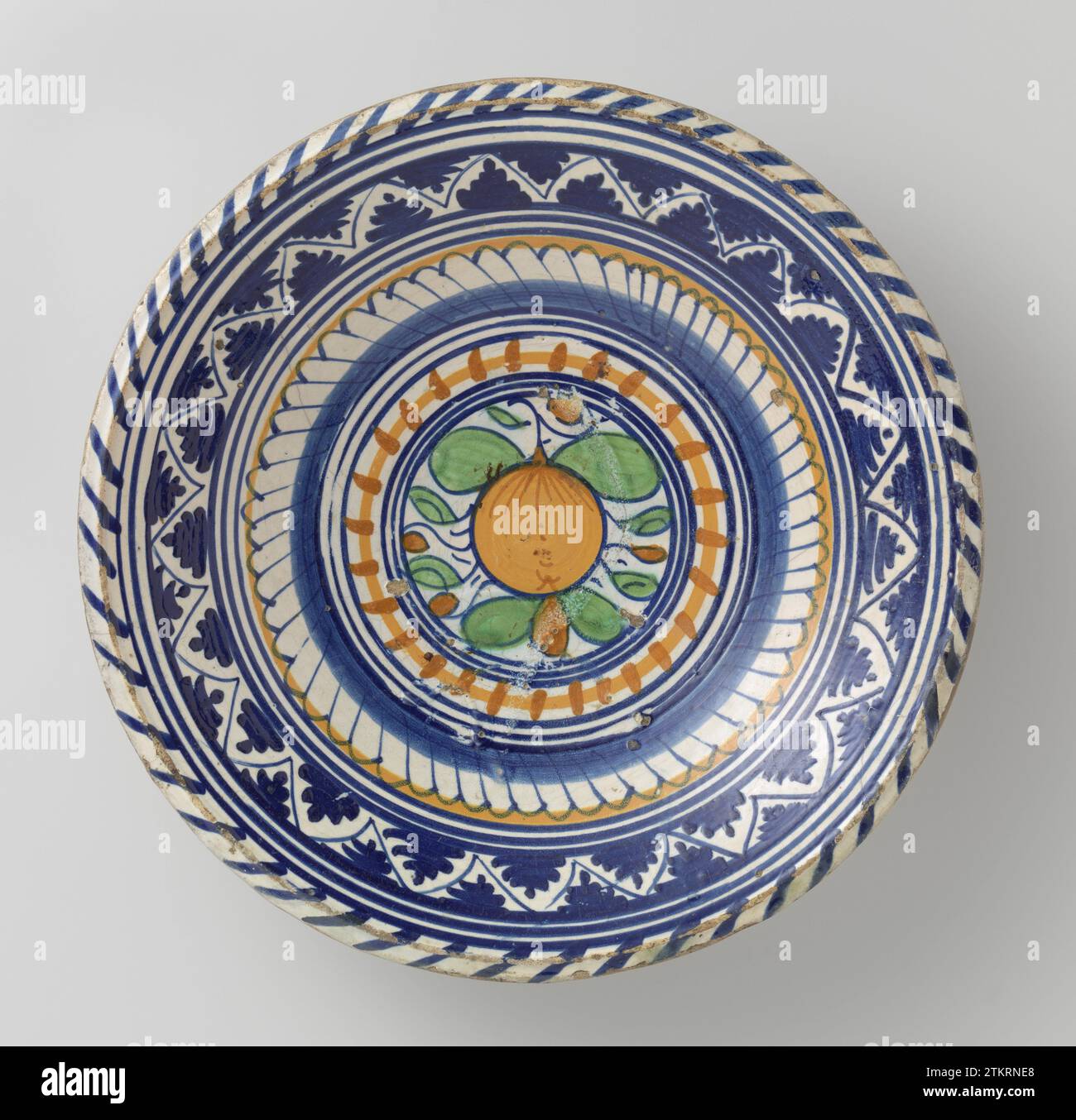 Saucer, multicolored painted with a southern fruit inside concentric ...