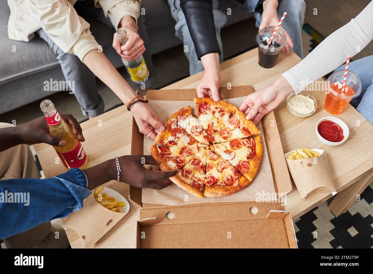 People Taking Pizza Slices at Party Stock Photo