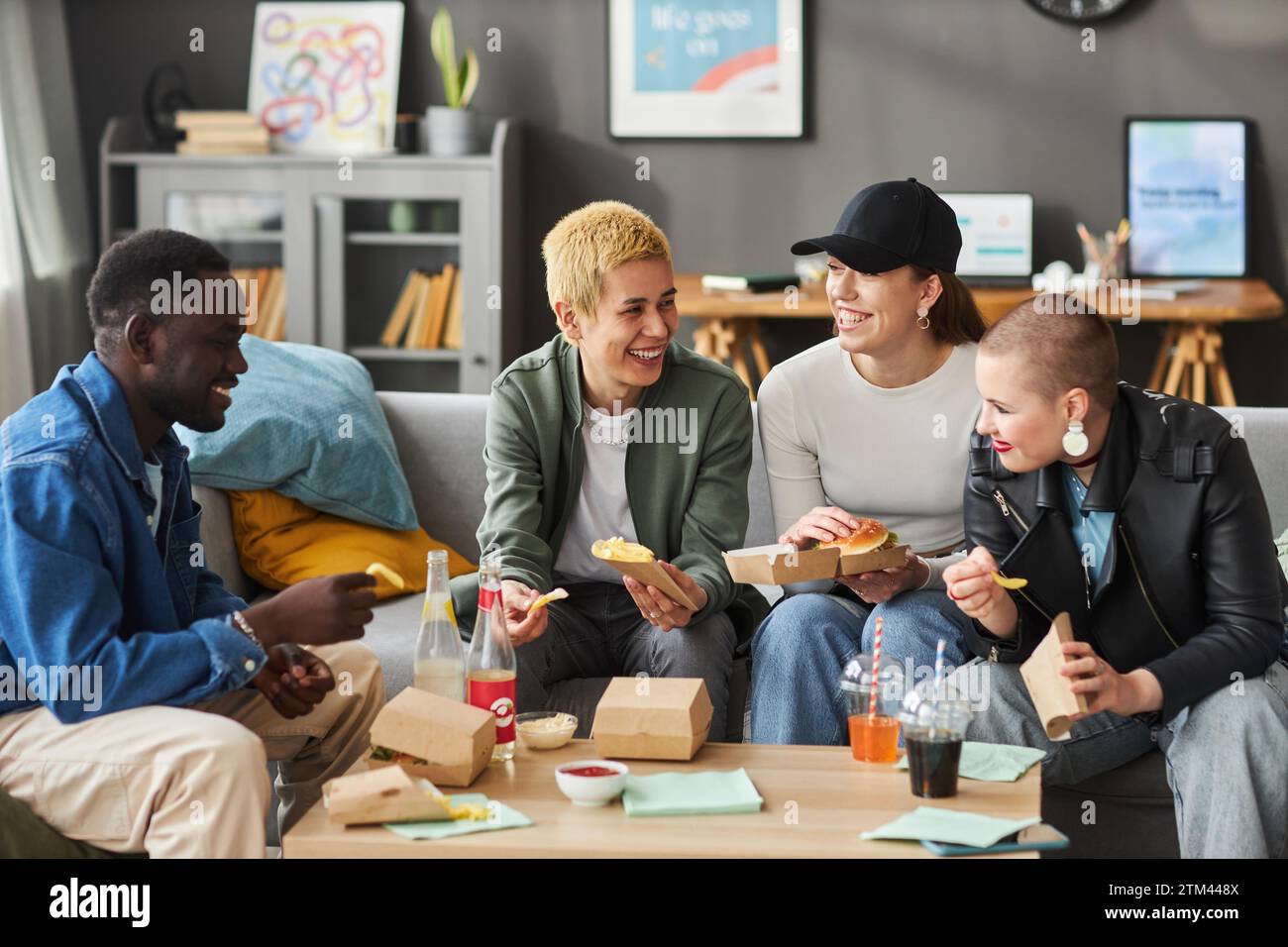 Smiling Young Adults Eating Fast Food Stock Photo