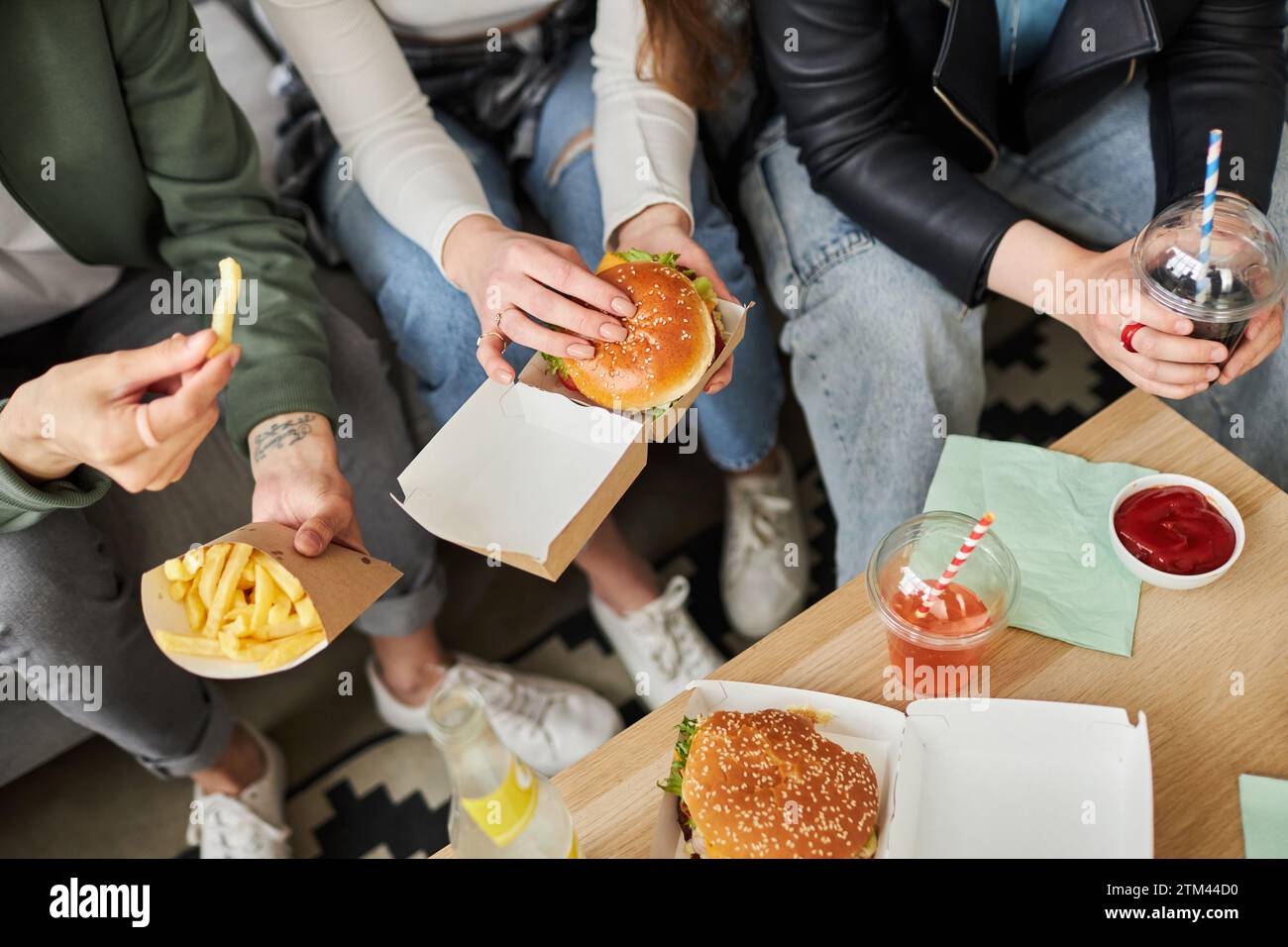 Friends Eating Fast Food Stock Photo