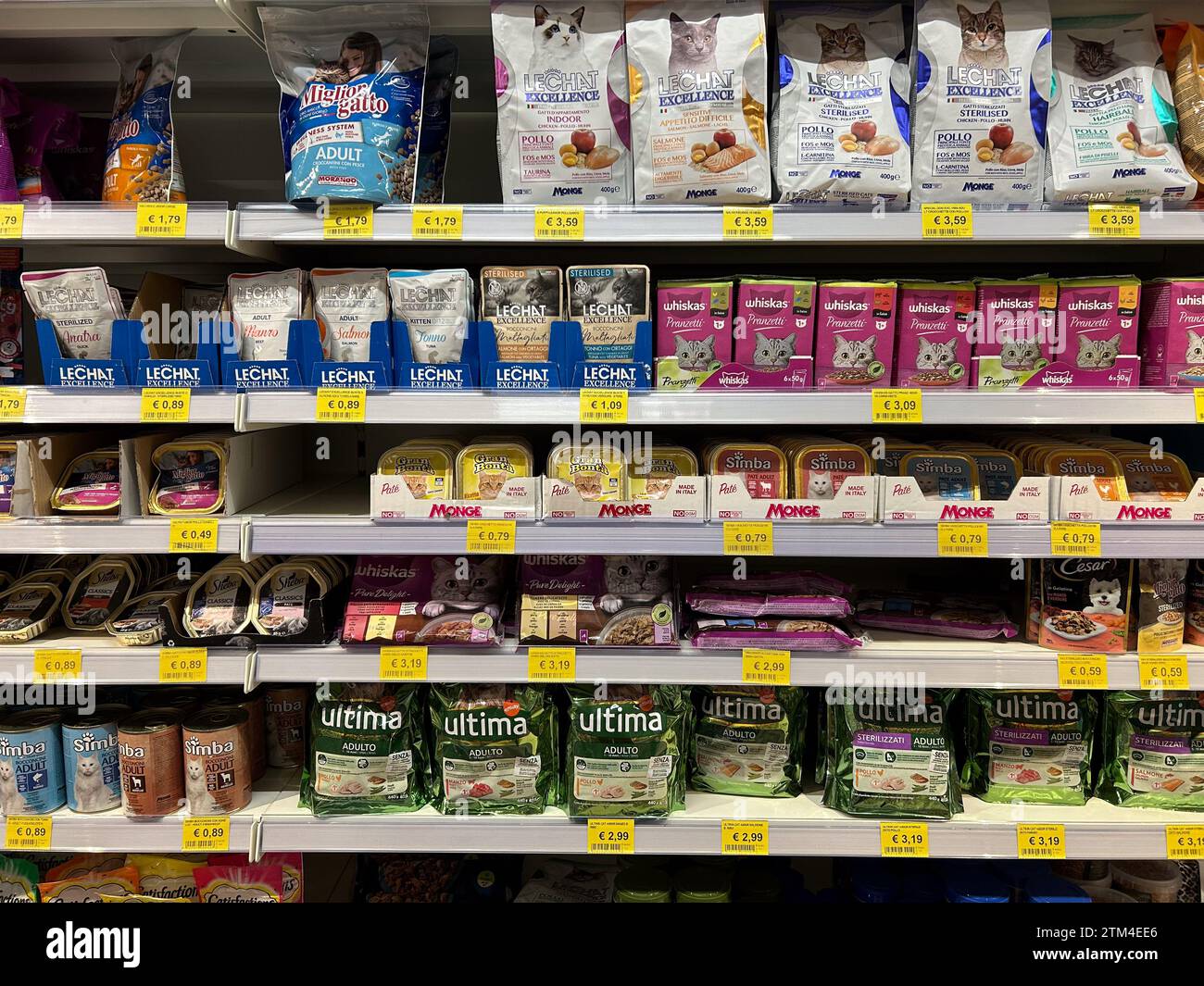Italy - December 20, 2023: Cat food in various kinds of packages of various brands displayed on shelves for sale in Italian supermarket Stock Photo