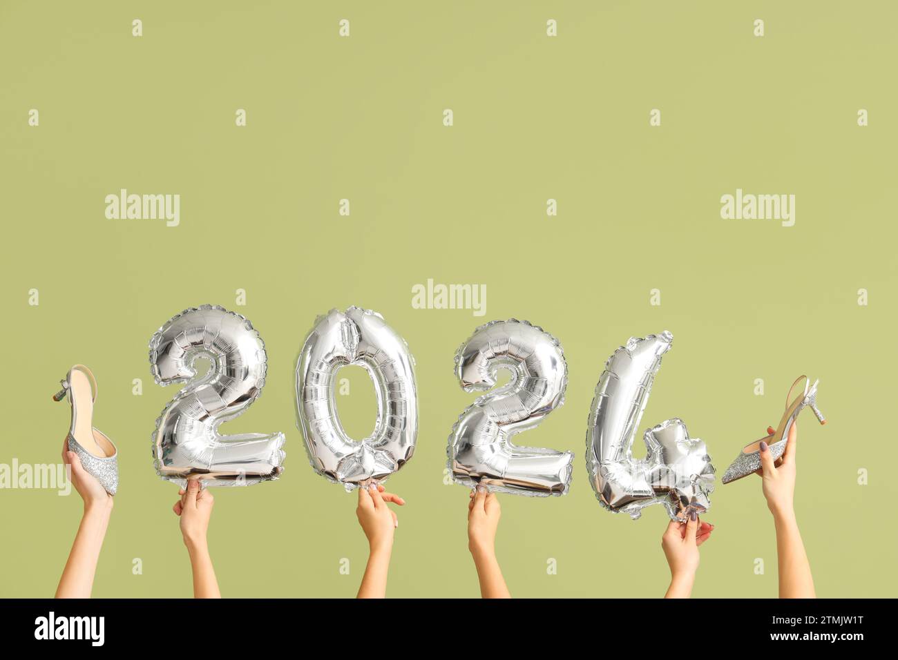 Female Hands With Shoes And Figure 2024 On Green Background New Year   Female Hands With Shoes And Figure 2024 On Green Background New Year Shopping Concept 2TMJW1T 