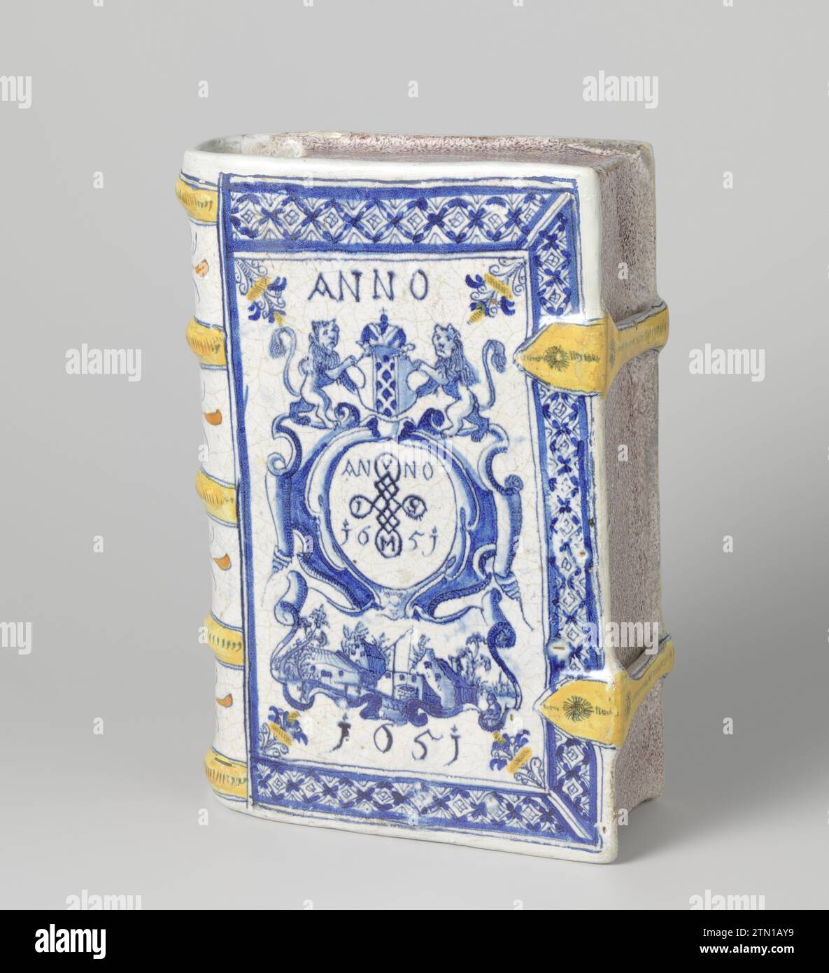 Drinking cup in the form of a book. Multicolored painted and with year: Anno 1651., Anonymous, 1651 Drinking cup of multicolored painted Majolica, in the form of a book. A cartouche has been painted on the front and back in which the dating: in 1651 and above which the weapon of Amsterdam. Four rosettes are painted on the back. Holland earthenware. tin glaze. lead glaze majolica  Amsterdam Drinking cup of multicolored painted Majolica, in the form of a book. A cartouche has been painted on the front and back in which the dating: in 1651 and above which the weapon of Amsterdam. Four rosettes ar Stock Photo