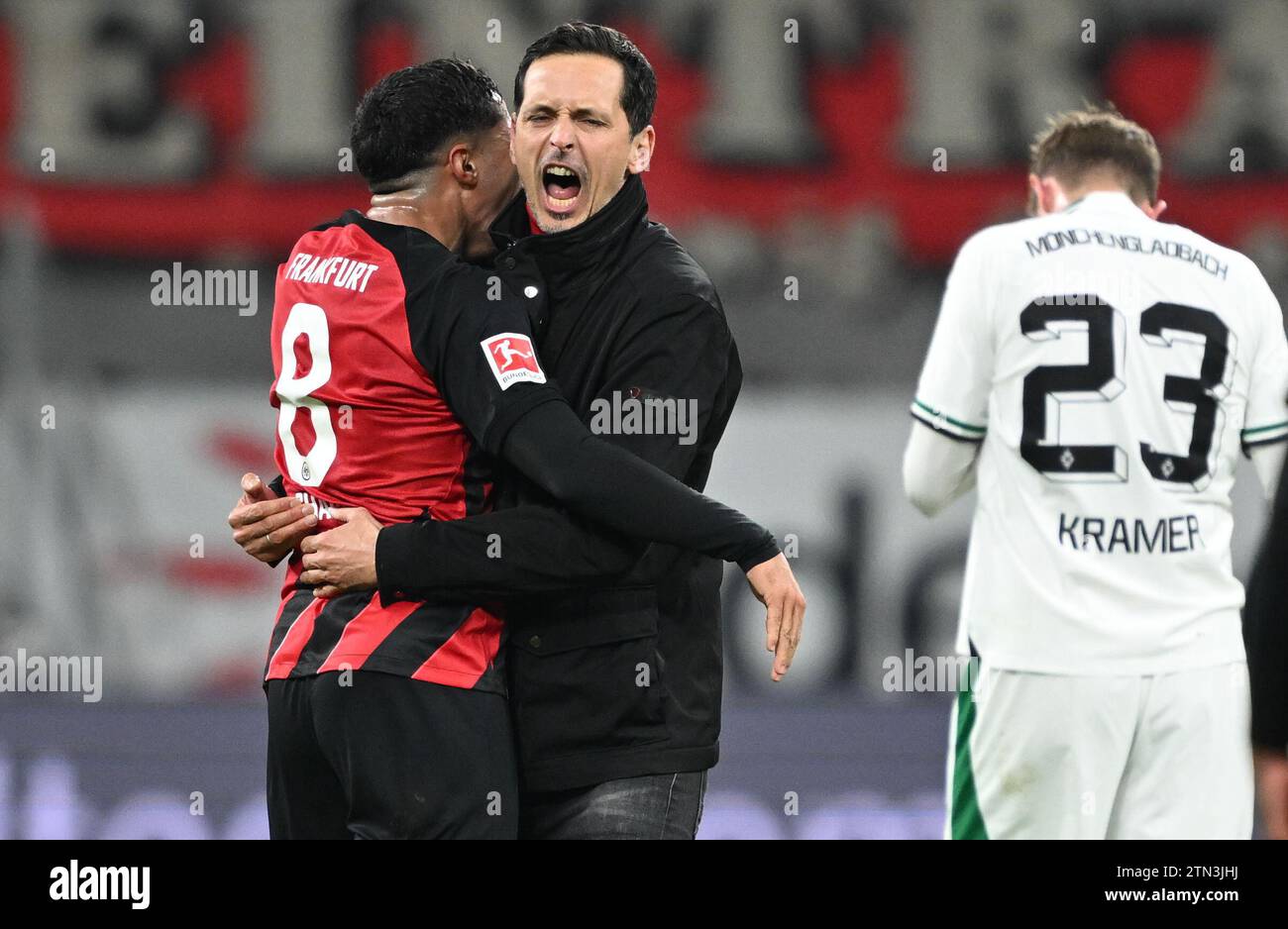 20 December 2023, Hesse, Frankfurt/Main: Soccer: Bundesliga, Eintracht Frankfurt - Borussia Mönchengladbach, matchday 16, at Deutsche Bank Park. Frankfurt's head coach Dino Toppmöller (M) and Farès Chaibi (l) celebrate after the 2:1 victory next to Mönchengladbach's Christoph Kramer. Photo: Arne Dedert/dpa - IMPORTANT NOTE: In accordance with the regulations of the DFL German Football League and the DFB German Football Association, it is prohibited to utilize or have utilized photographs taken in the stadium and/or of the match in the form of sequential images and/or video-like photo series. Stock Photo