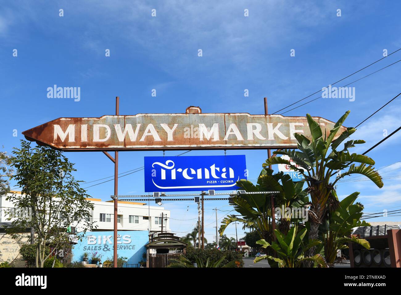 COSTA MESA, CALIFORNIA - 17 DEC 2023: Midway Market sign at the rough-edged bloom of businesses tucked in the middle of warehouses and auto body shops Stock Photo