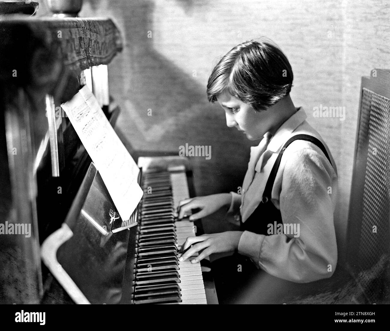 Girl playing piano Black and White Stock Photos & Images - Alamy