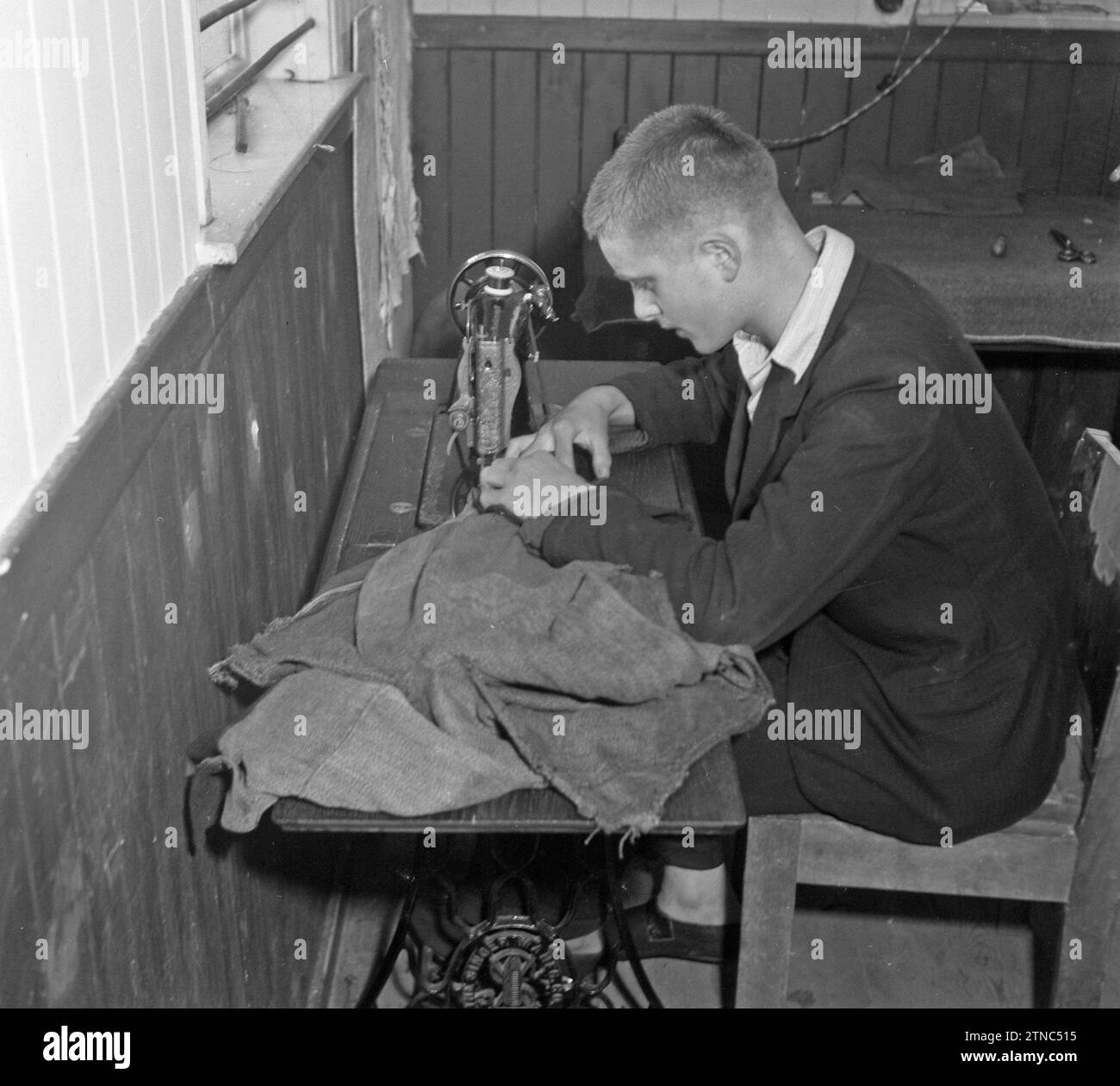Boy behind a sewing machine ca. October 1945 Stock Photo - Alamy