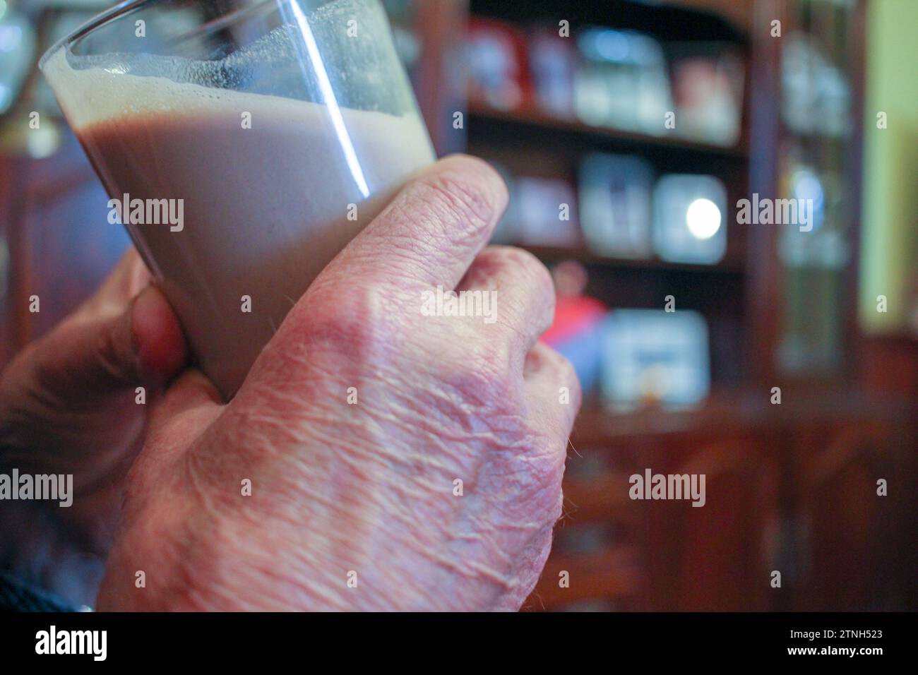 Nourishing Years: Octogenarian Hands Embrace a Nutrient-Packed Shake Stock Photo