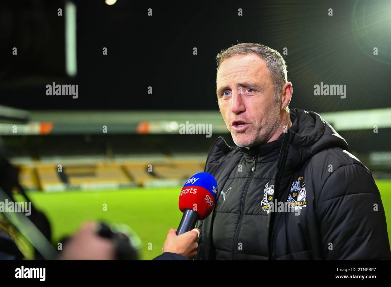 Burslem, UK, 19th December 2023. Port Vale Manager Andy Crosby delivers a post match interview to Sky Sports after his side exit the Carabao Cup at home to Middlesbrough. Credit: TeeGeePix/Alamy Live News Stock Photo