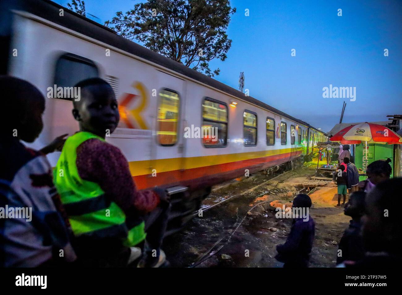The late evening Nairobi to Kisumu passenger train drives past Kibera