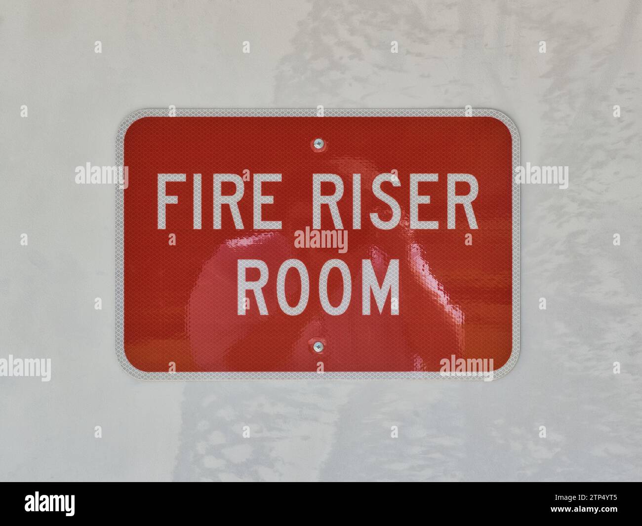 Fire Riser Room location sign isolated on an exterior door. Control center cabinet room for a commercial building's fire sprinkler system. Stock Photo