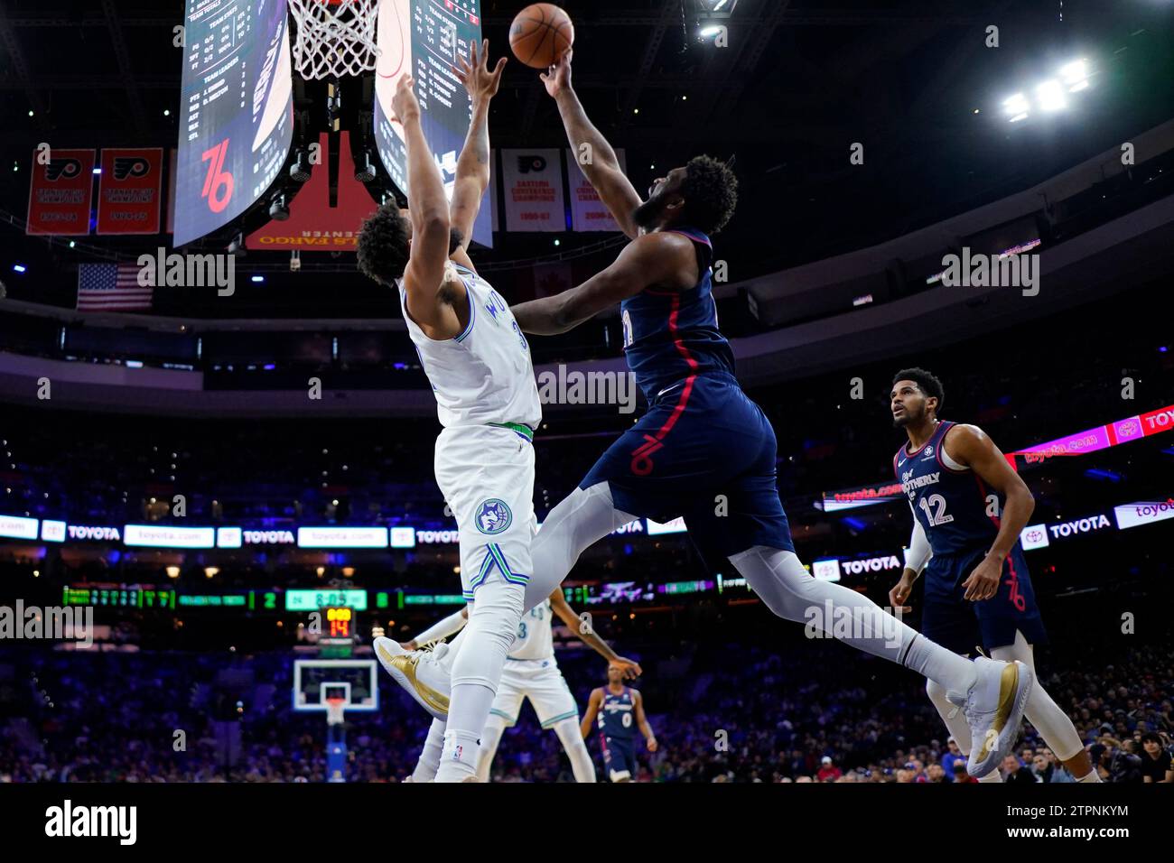 Philadelphia 76ers' Joel Embiid, center, goes up for a shot against ...