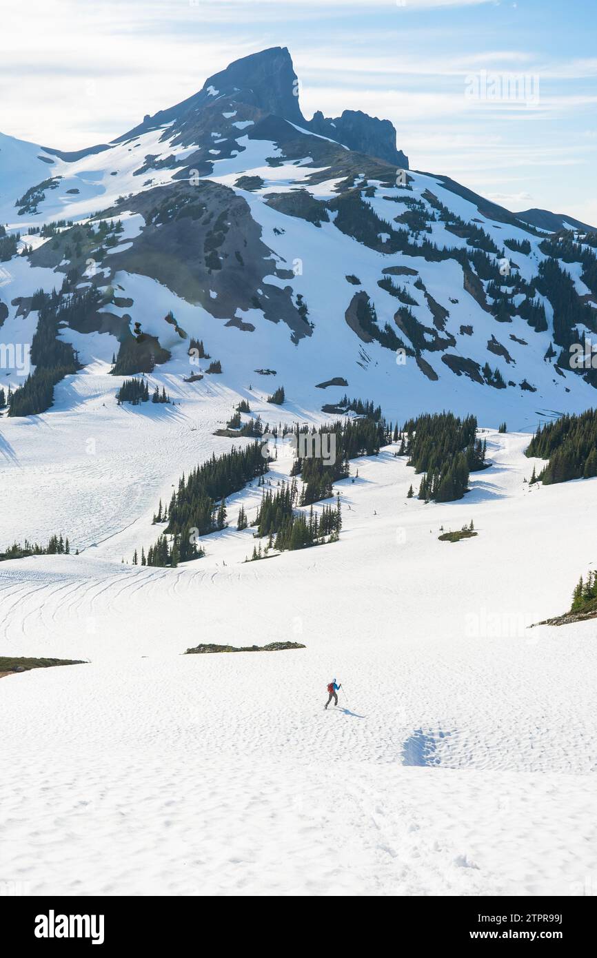 Lone hiker on Panorama Ridge with the striking Black Tusk in the distance. Stock Photo