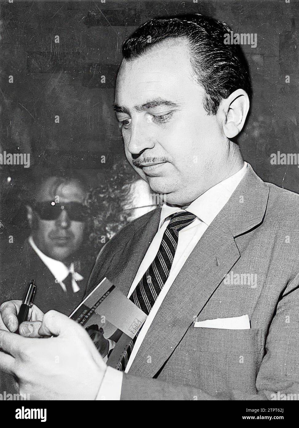 Ángel González Signing Copies of his Work 'without Hope, with Conviction', at the 1963 Book Fair. Credit: Album / Archivo ABC / Álvaro García Pelayo Stock Photo