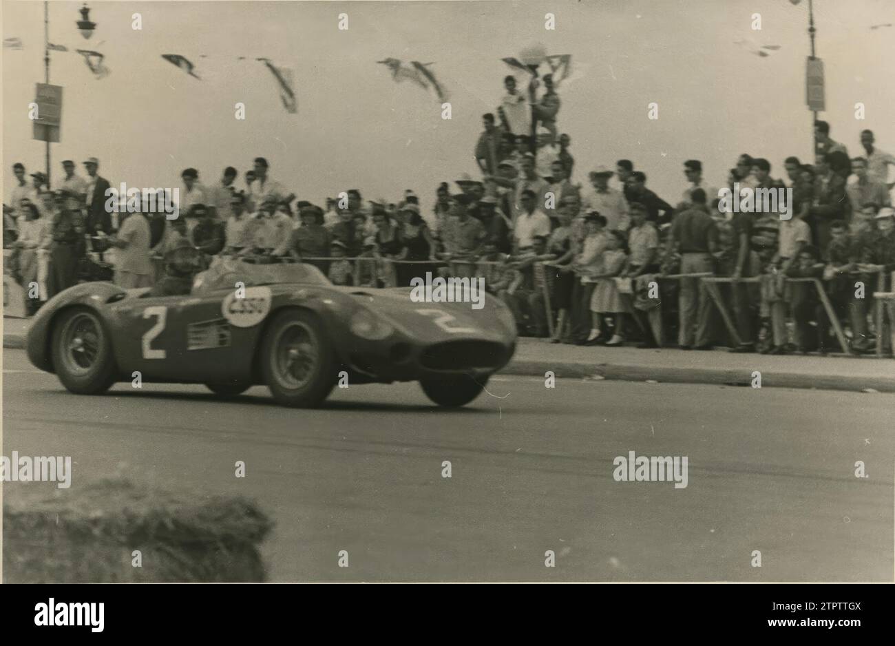March 1957. The World Champion, Juan Manuel Fangio, entering the finish line. Credit: Album / Archivo ABC Stock Photo