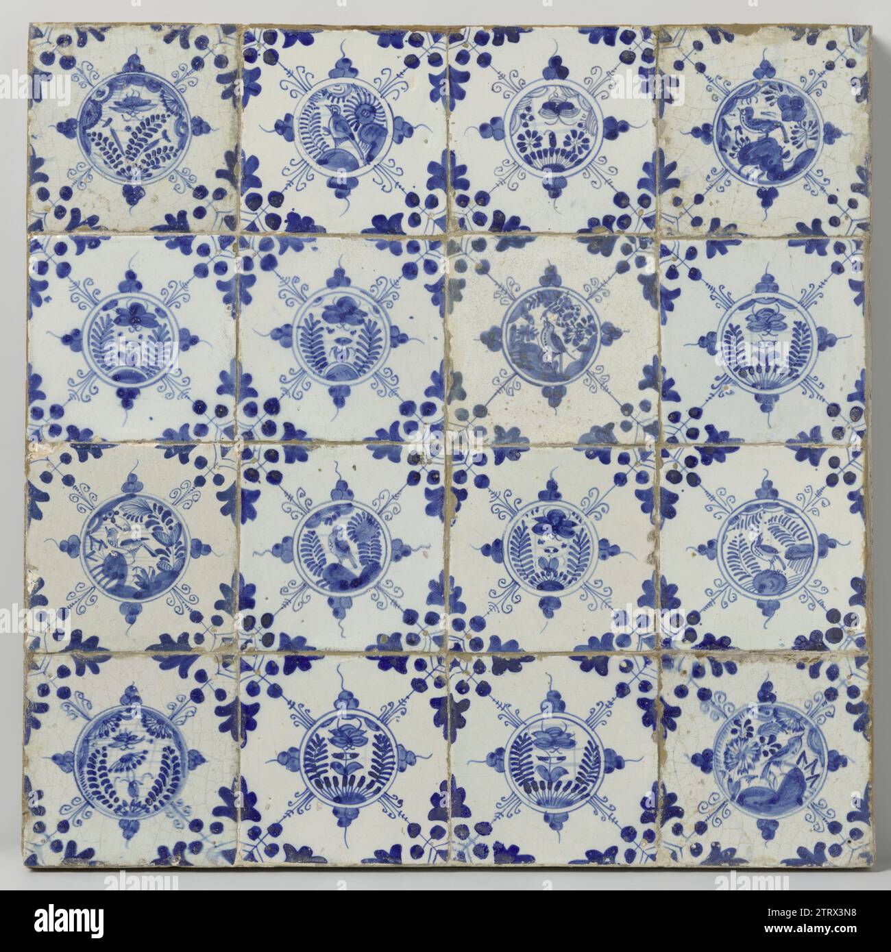 Field of sixteen tiles with birds and butterflies, anonymous, c. 1620 - c. 1640 Field of sixteen tiles (4 x 4) each with a blue -painted bird or butterfly in a Chinese garden inside a circle. In the corners, a three -way tip. Netherlands earthenware. tin glaze majolica Field of sixteen tiles (4 x 4) each with a blue -painted bird or butterfly in a Chinese garden inside a circle. In the corners, a three -way tip. Netherlands earthenware. tin glaze majolica Stock Photo