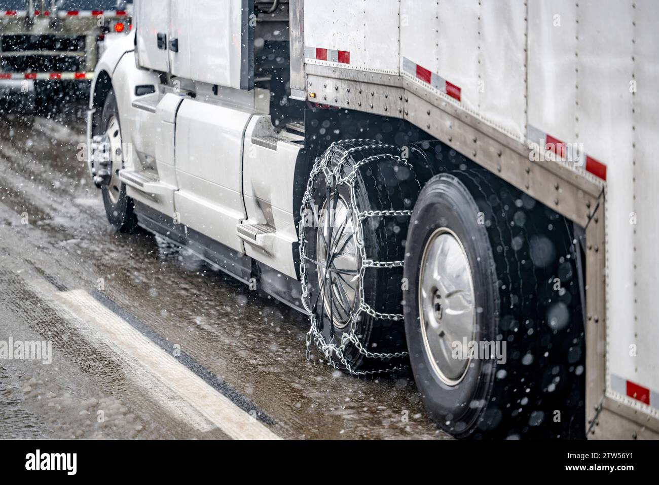 Required chains for better grip on slippery road surfaces on a white