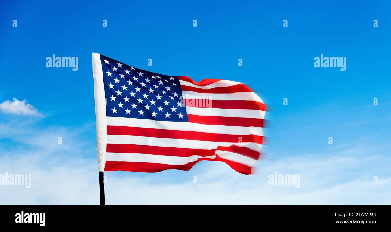 American flag waving on blue sky background Stock Photo - Alamy