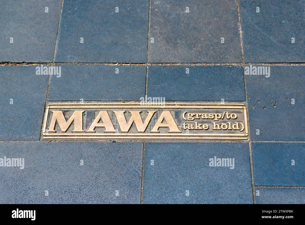 Aboriginal language words on brass plates embedded in the pavement of Martin Place in Sydney, Australia Stock Photo