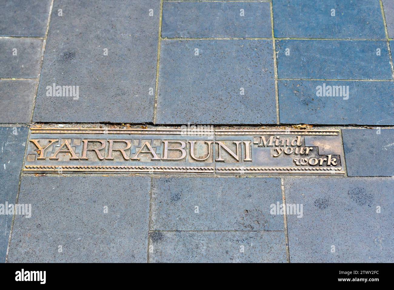 Aboriginal language words on brass plates embedded in the pavement of Martin Place in Sydney, Australia Stock Photo