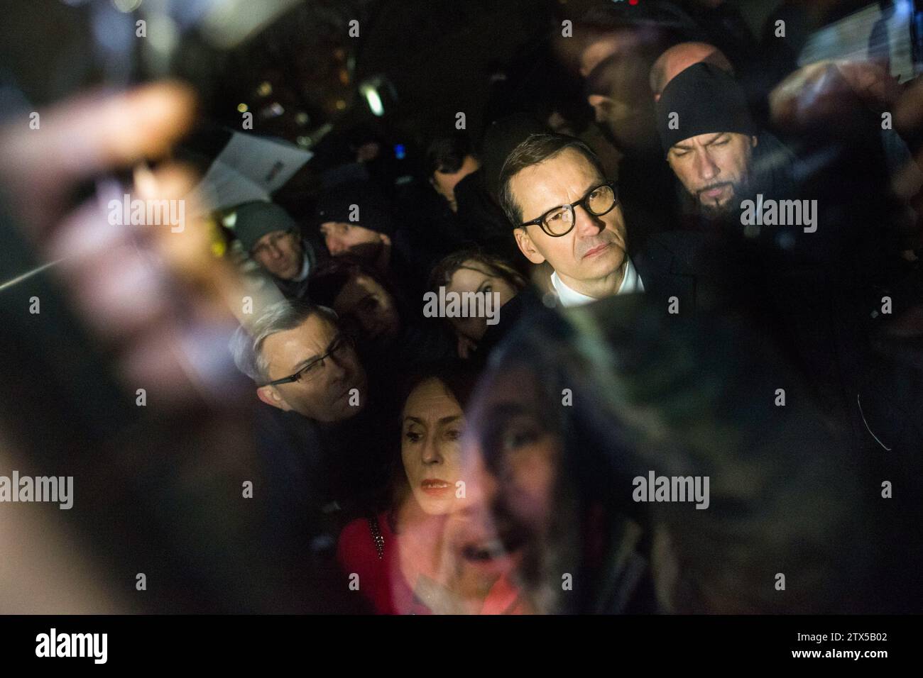 Mateusz Morawiecki, former prime minister tries to enter into the state TV (TVP) headquarters after it was blocked and surrounded by police forces. Poland's new pro-European Union government said Wednesday that it had changed the directors of state television in Poland known as TVP, radio and the government-run news agency as it embarked on the path of freeing publicly-owned media from the political control of the previous nationalist conservative administration. The Cabinet of Prime Minister Donald Tusk, which took office last week, has made it a priority to restore objectivity and free expre Stock Photo