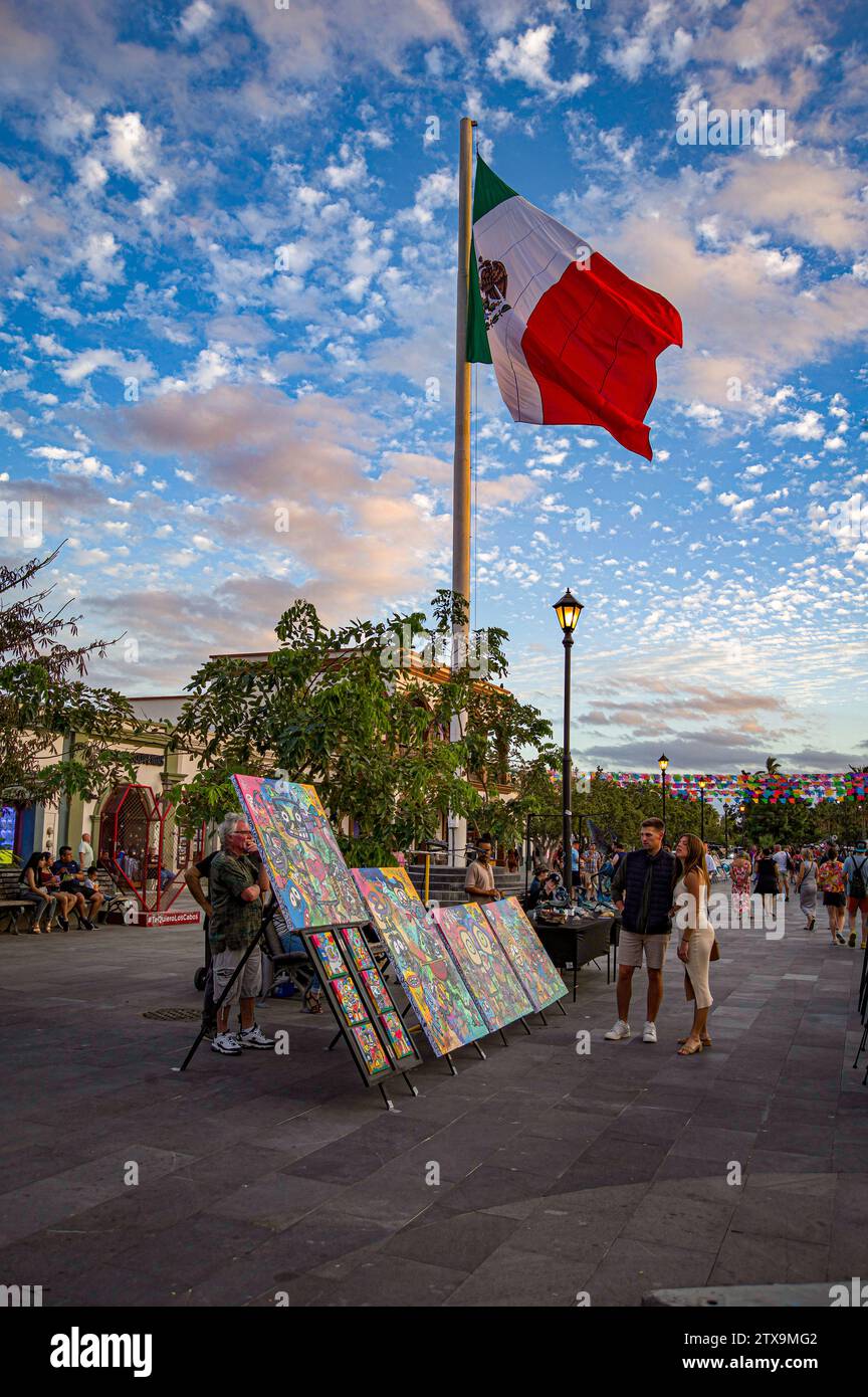 A couple looks at artwork on display during the Thursday night art walk in the Plaza Mijares. Stock Photo