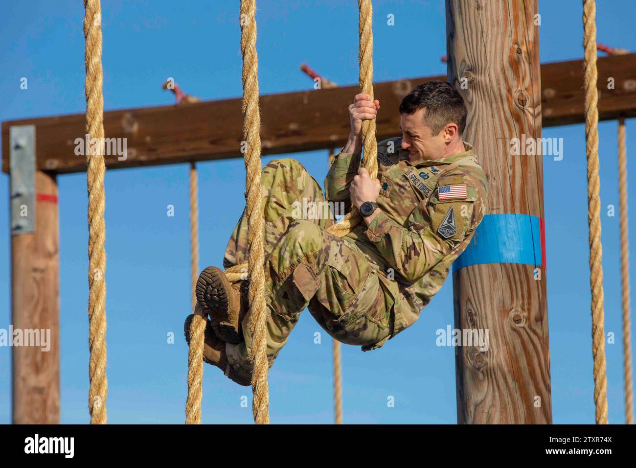 San Diego, California, USA. 15th Dec, 2023. U.S. Space Force Lt. Col. Mike LaSorda, a ground modernization material leader, with Narrowband Satellite Command, climbs a rope at Marine Corps Recruit Depot San Diego, California, December. 15, 2023. Members of the U.S. Space Force visited MCRD San Diego to familiarize their unit with the Marine Corps Obstacle Course and participate in a team building exercise. (Credit Image: © U.S. Marines/ZUMA Press Wire) EDITORIAL USAGE ONLY! Not for Commercial USAGE! Stock Photo